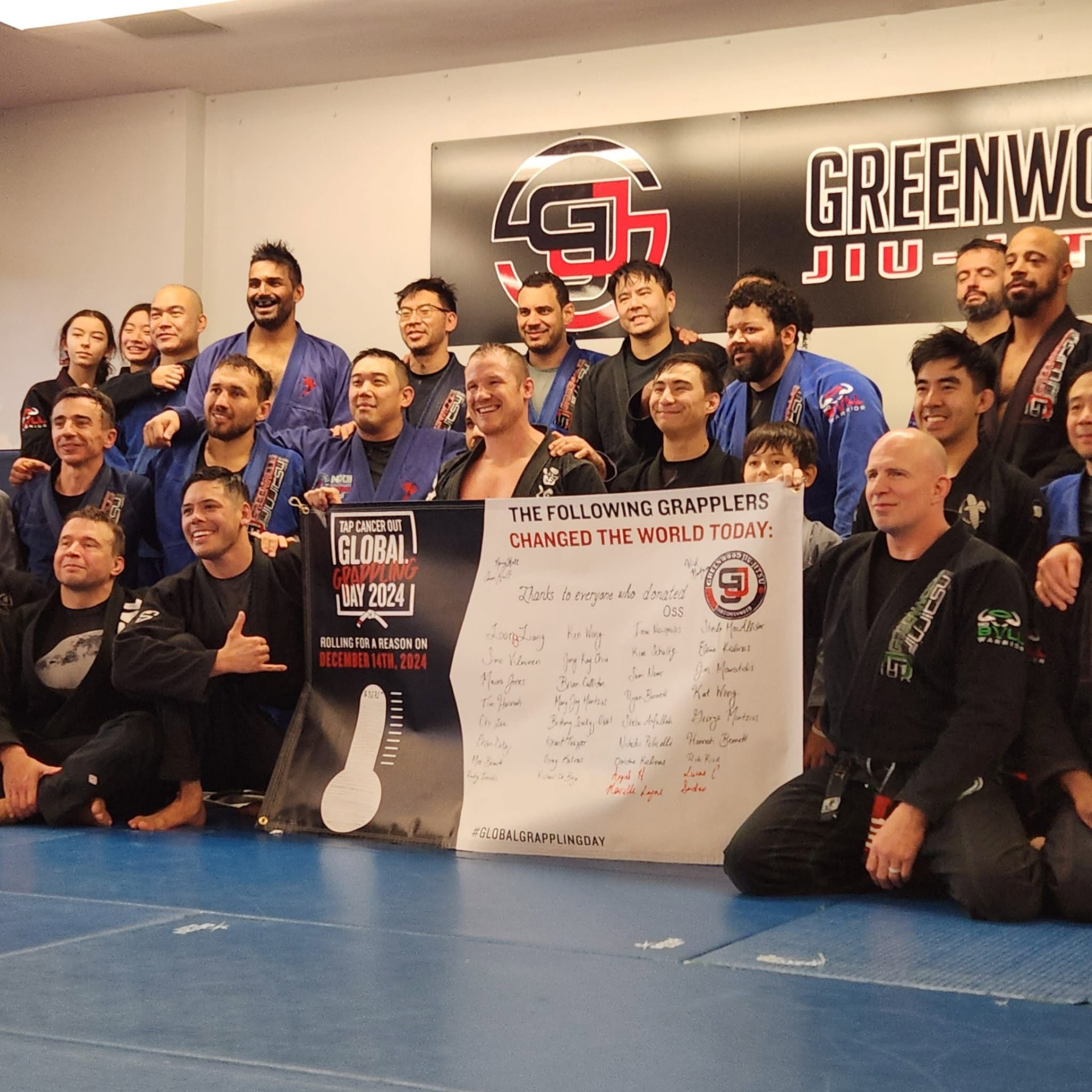 Grapplers celebrating a Global Grappling Day fundraiser